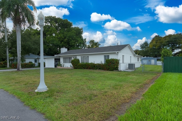 view of front of house featuring central AC and a front yard