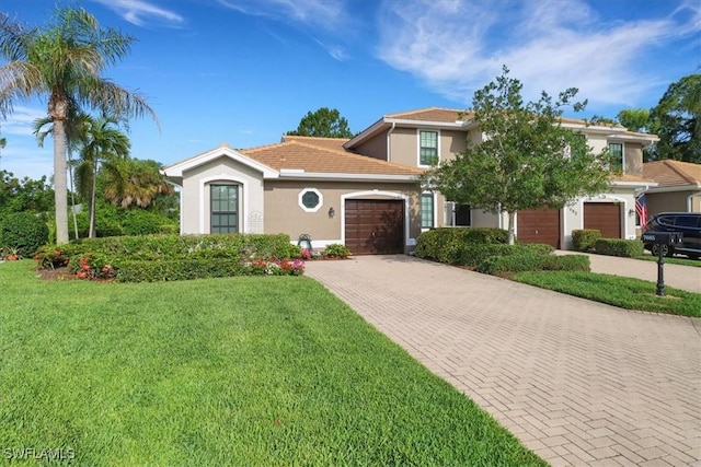 7685 Meadow Lakes Dr Unit 1301, Naples, FL 34104 - view of front of house with decorative driveway, stucco siding, a front yard, and an attached garage