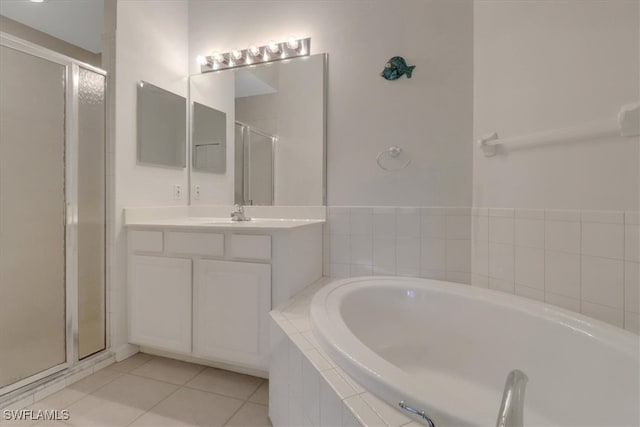7685 Meadow Lakes Dr Unit 1301, Naples, FL 34104 - bathroom featuring a stall shower, a bath, vanity, and tile patterned floors