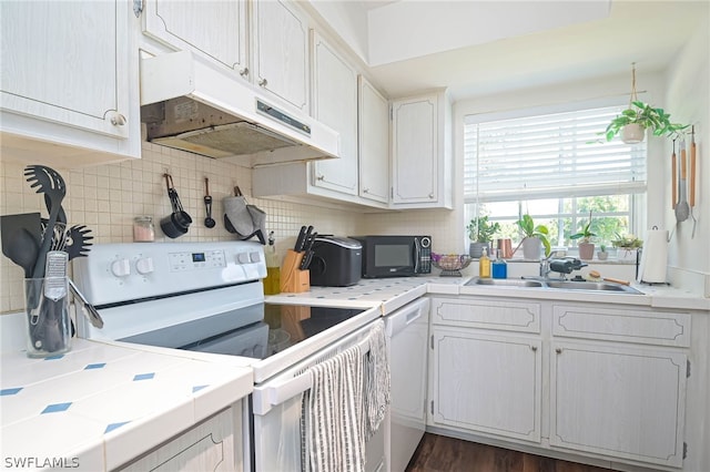 kitchen with tasteful backsplash, sink, tile counters, dark hardwood / wood-style floors, and white electric stove