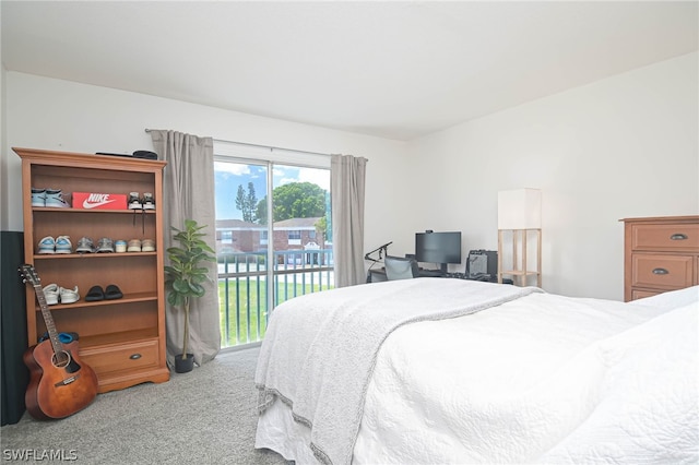 carpeted bedroom featuring multiple windows and access to exterior