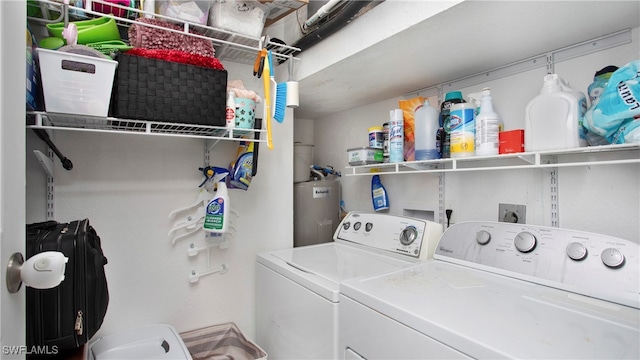 laundry area with washing machine and dryer and water heater