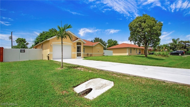 single story home featuring a garage and a front lawn