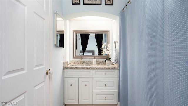 bathroom with walk in shower and vanity