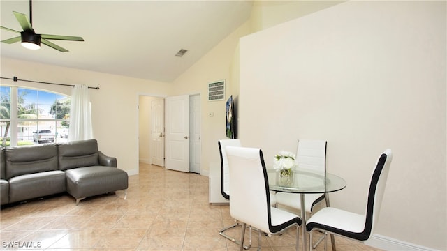 dining room featuring lofted ceiling, ceiling fan, and light tile patterned flooring