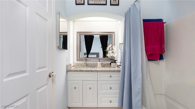 bathroom featuring vanity and shower / bath combination with curtain