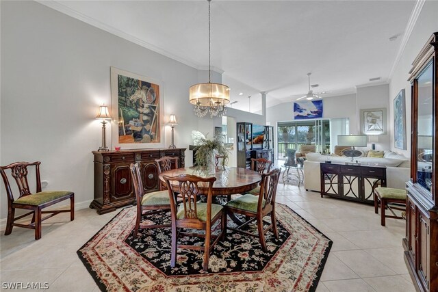 dining area featuring ceiling fan with notable chandelier, light tile patterned floors, crown molding, and lofted ceiling