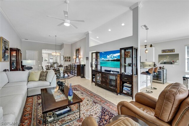 tiled living room featuring ceiling fan with notable chandelier, ornamental molding, and lofted ceiling