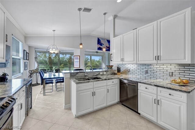 kitchen featuring kitchen peninsula, appliances with stainless steel finishes, vaulted ceiling, sink, and pendant lighting