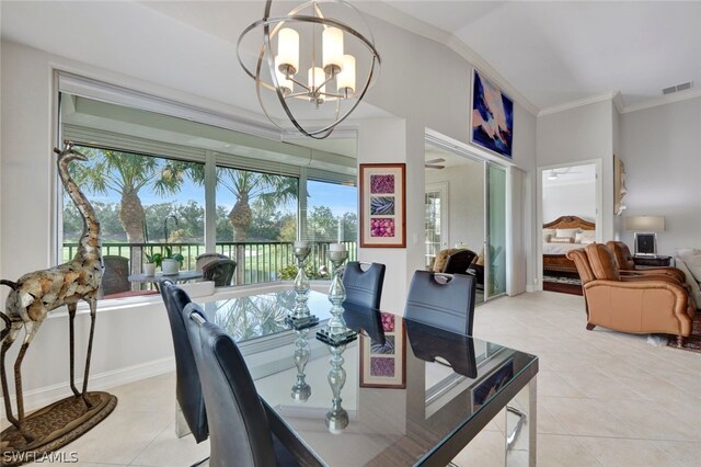 tiled dining space featuring ornamental molding, lofted ceiling, and a notable chandelier