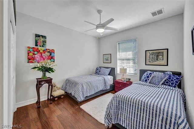 bedroom featuring ceiling fan and dark hardwood / wood-style floors