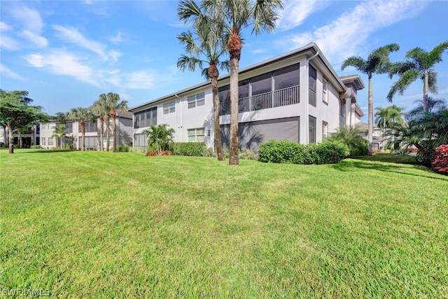 rear view of property featuring a yard