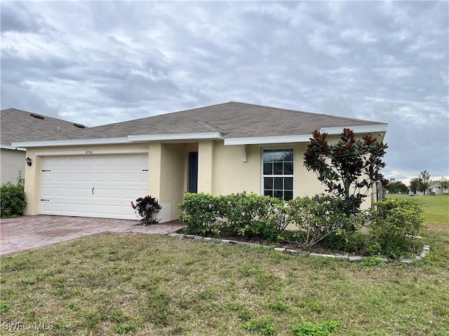 view of front of property with a front yard and a garage