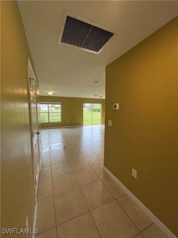 hall with light tile patterned floors