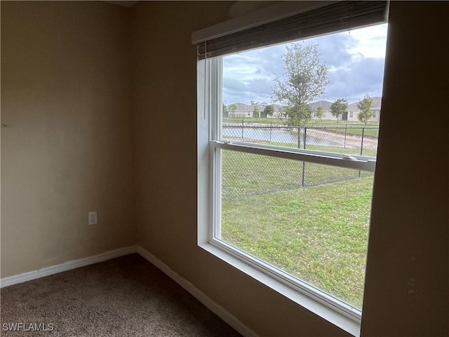 empty room featuring carpet floors and a water view