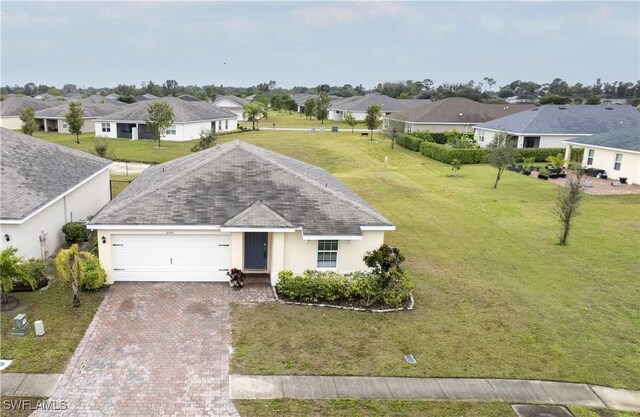 view of front of property with a garage and a front yard