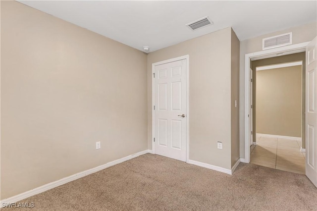 unfurnished bedroom with light colored carpet