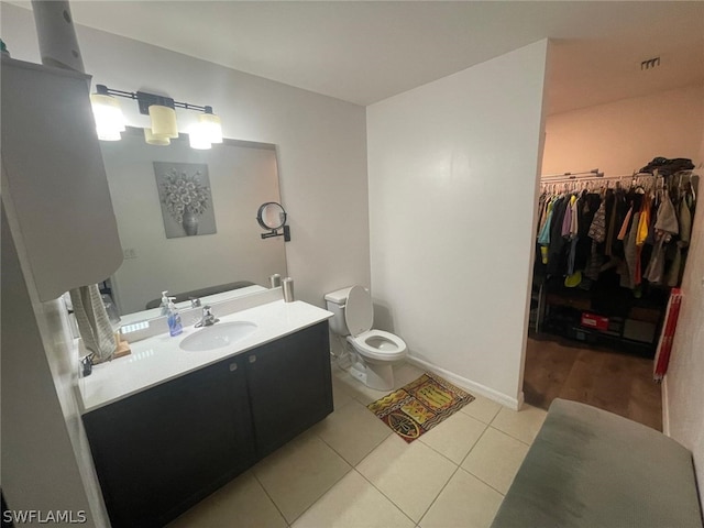 bathroom featuring vanity, tile patterned flooring, and toilet