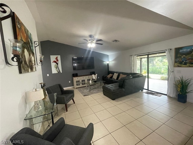 living room with ceiling fan, vaulted ceiling, and light tile patterned floors