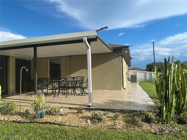 back of house featuring a patio and central air condition unit