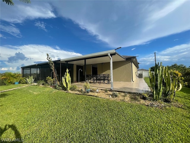 back of property with a patio and a yard