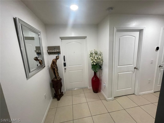 corridor with light tile patterned flooring