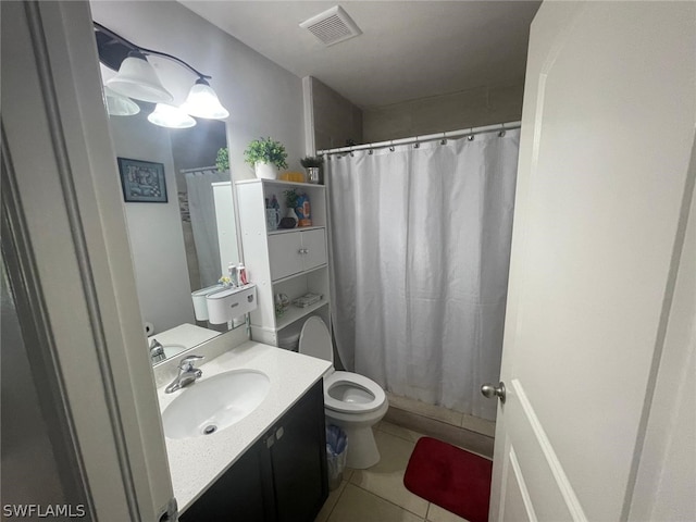 bathroom with vanity, tile patterned floors, toilet, and walk in shower