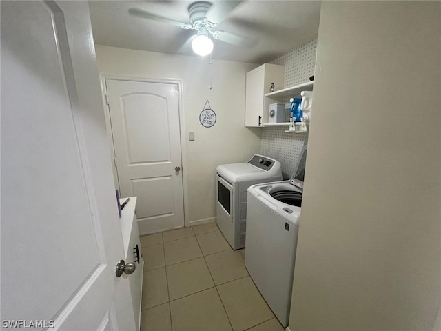 laundry area with light tile patterned floors, washing machine and dryer, cabinets, and ceiling fan