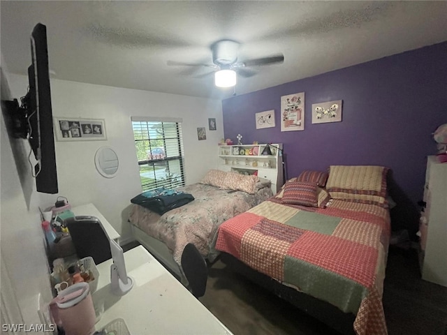 bedroom featuring a textured ceiling and ceiling fan