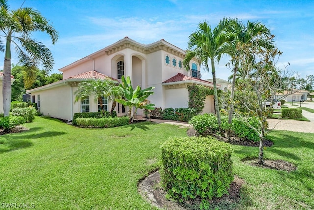 7787 Martino Cir, Naples, FL 34112 - mediterranean / spanish home featuring stucco siding, a front lawn, and a tile roof