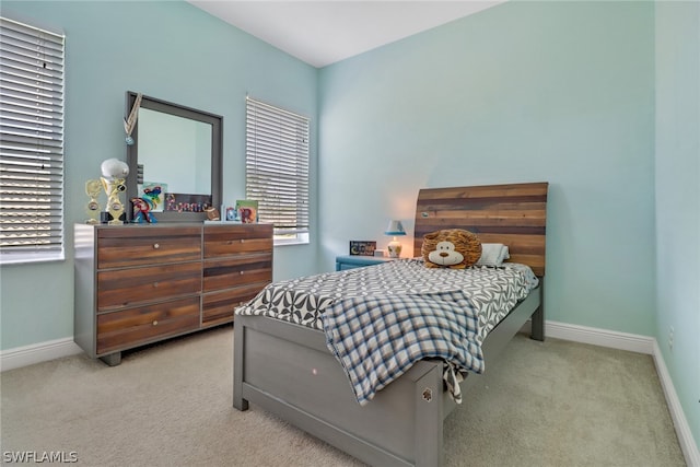 bedroom featuring light carpet