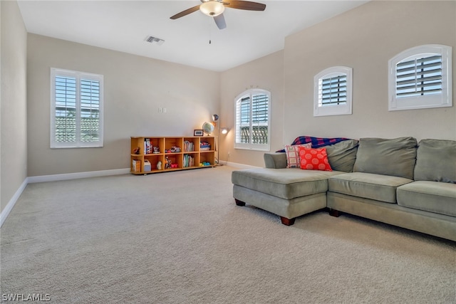 carpeted living room featuring ceiling fan and a healthy amount of sunlight