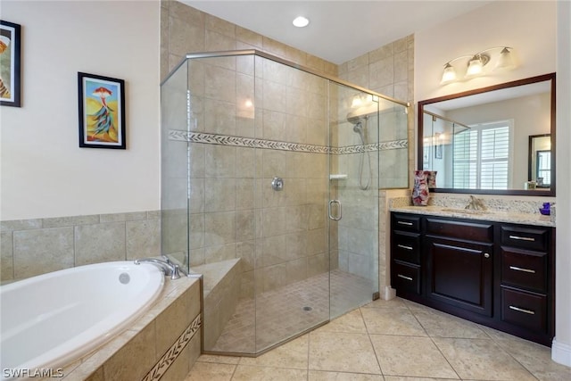 bathroom featuring tile patterned floors, vanity, and independent shower and bath