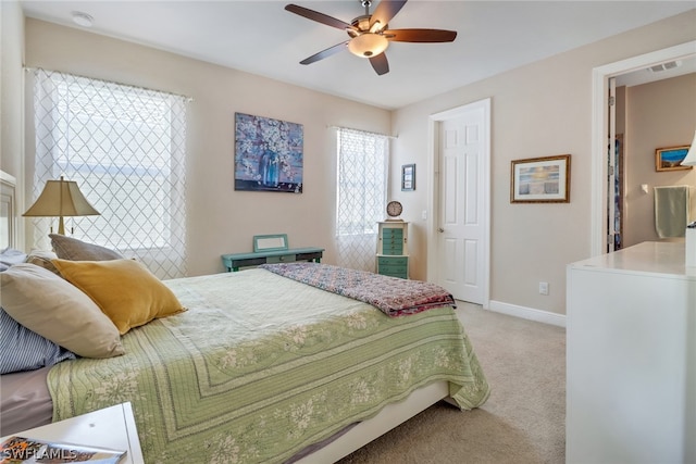 bedroom featuring ceiling fan and light carpet