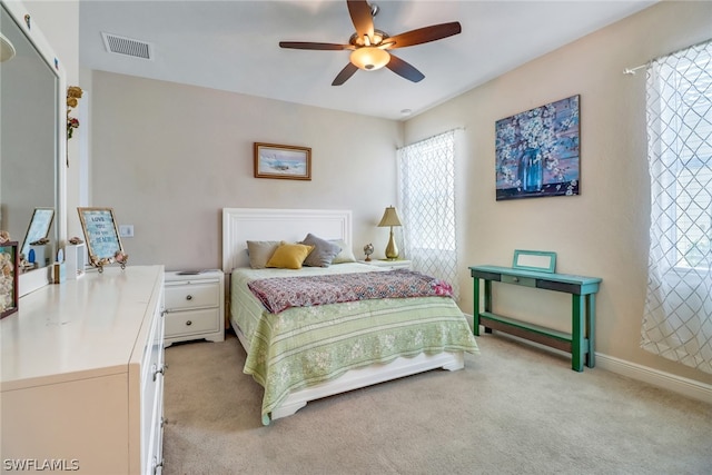 bedroom featuring ceiling fan and light colored carpet