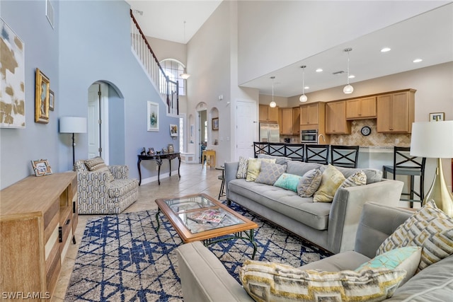 tiled living room featuring a high ceiling