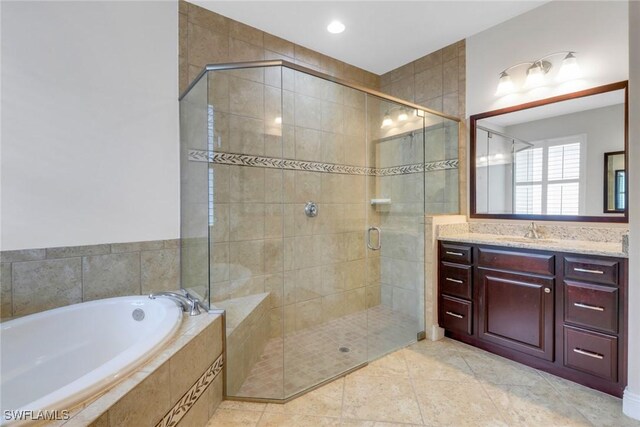 7787 Martino Cir, Naples, FL 34112 - bathroom featuring a garden tub, vanity, a stall shower, and tile patterned floors