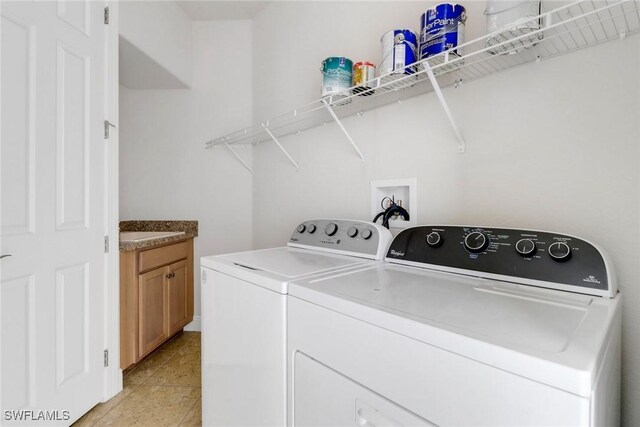 7787 Martino Cir, Naples, FL 34112 - washroom with separate washer and dryer, light tile patterned flooring, and cabinet space