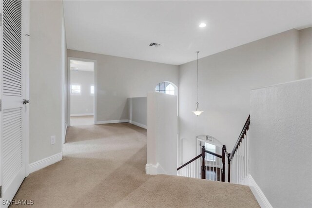 7787 Martino Cir, Naples, FL 34112 - corridor featuring an upstairs landing, carpet flooring, healthy amount of natural light, and recessed lighting