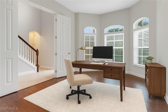 7787 Martino Cir, Naples, FL 34112 - office area with plenty of natural light, wood finished floors, and arched walkways