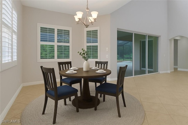 7787 Martino Cir, Naples, FL 34112 - dining space with a chandelier, light tile patterned floors, and arched walkways