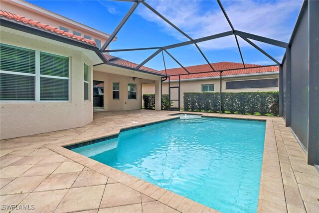 7787 Martino Cir, Naples, FL 34112 - swimming pool with a patio area, a hot tub, and a lanai
