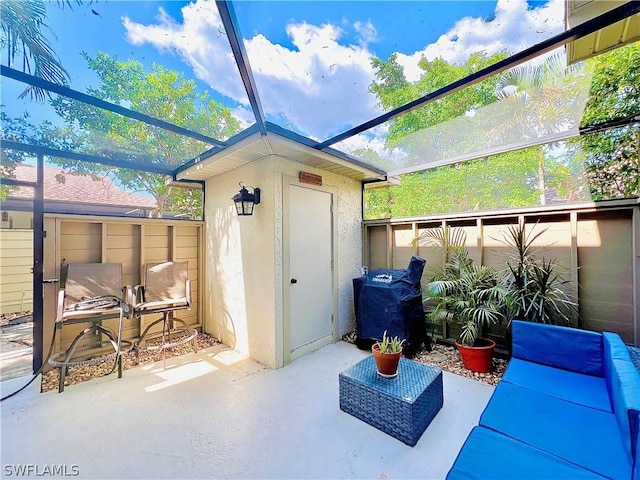 view of patio / terrace with a storage unit and a lanai