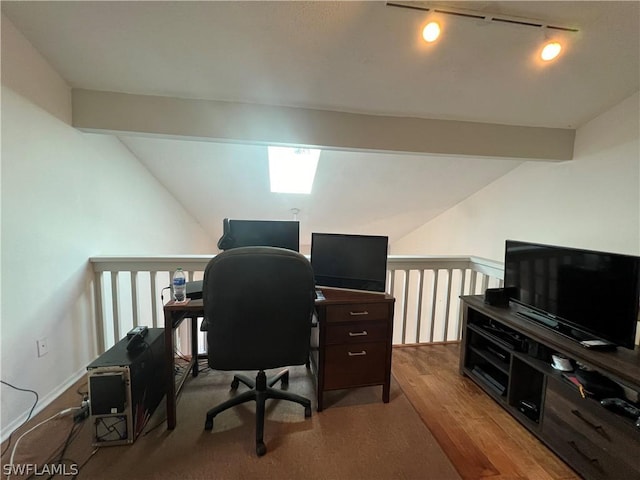 office featuring vaulted ceiling, rail lighting, and wood finished floors