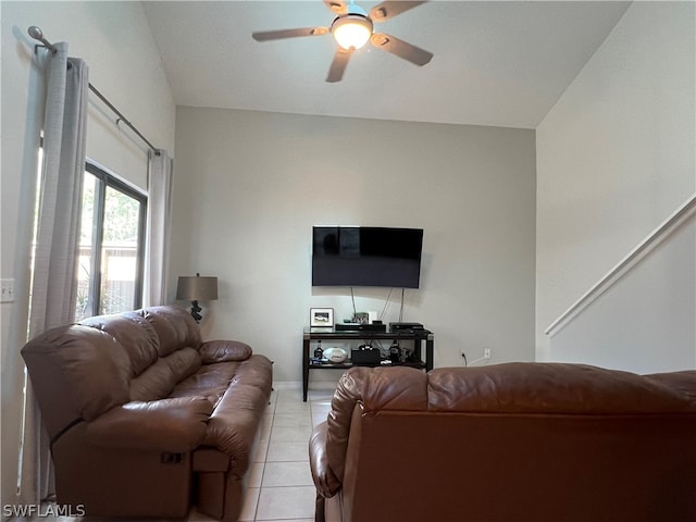 tiled living room with ceiling fan and lofted ceiling