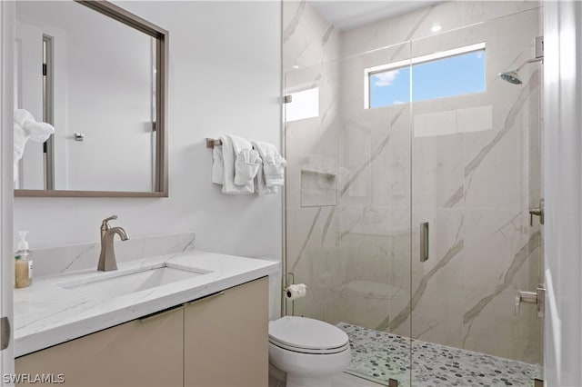 bathroom with vanity, toilet, and walk in shower