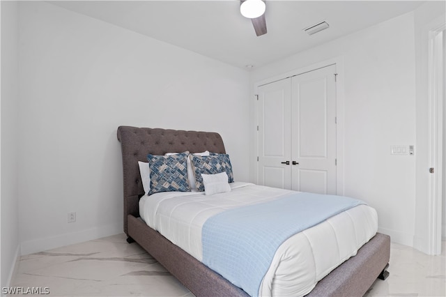 bedroom with ceiling fan and a closet