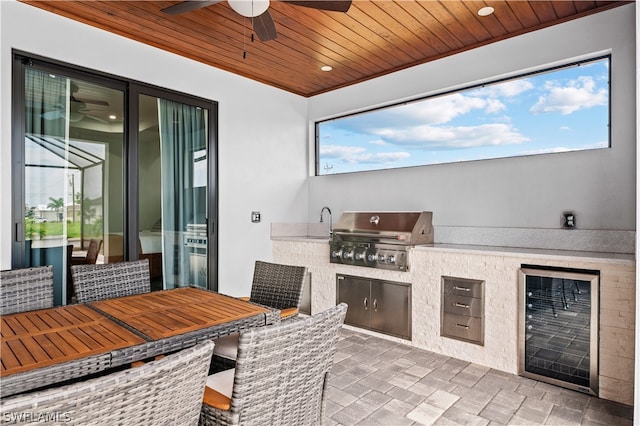 view of patio featuring wine cooler, grilling area, and ceiling fan