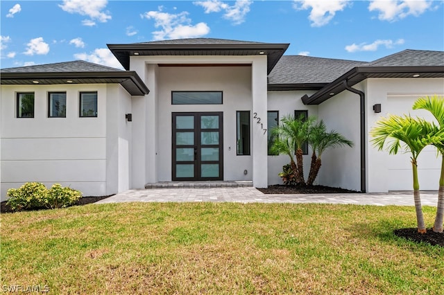 property entrance with a yard and french doors