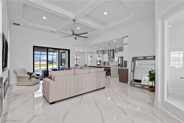 living room featuring beam ceiling, ceiling fan, and coffered ceiling